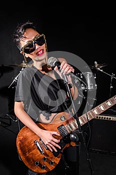 Young woman playing guitar during