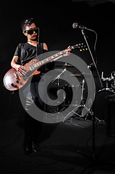 Young woman playing guitar during