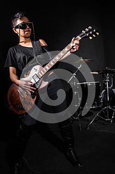 Young woman playing guitar during