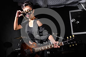 Young woman playing guitar during