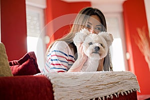 Young woman is playing with her dog