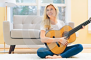 Young woman playing her guitar