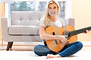 Young woman playing her guitar