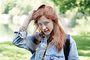 Young woman playing with her hair and giving a coy look