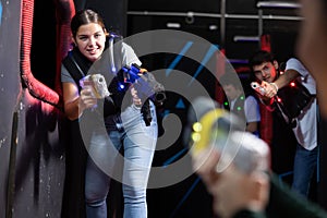 Young woman playing lasertag in arena