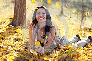 Young woman playing with leafs