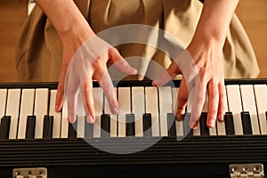 Young woman playing piano, above view. Music lesson