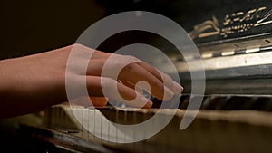 A young woman playing piano closeup. Piano hands pianist playing Musical instruments details with player hand closeup