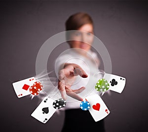 Young woman playing with poker cards and chips