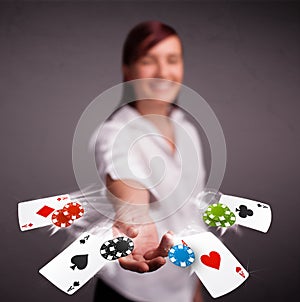 Young woman playing with poker cards and chips