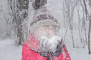 Young woman playing with snow