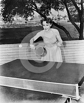 Young woman playing table tennis photo