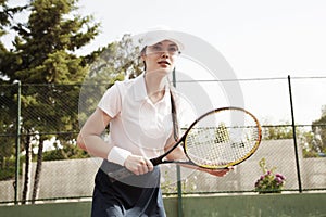 Young woman playing tennis on court