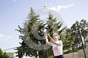 Young woman playing tennis on court.