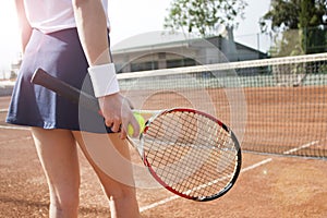 Young woman playing tennis on court.