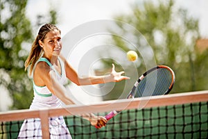 Young woman playing tennis outdoor