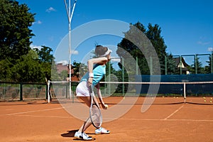 Young woman playing tennis, summertime saturated theme