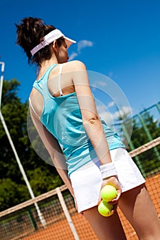 Young woman playing tennis, summertime saturated theme