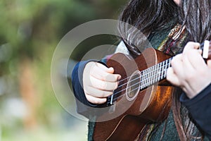 Young woman playing ukelele. Natural space. Copy-space