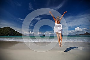 Young woman plays at the sea