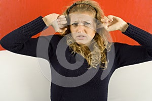 Young woman plug fingers in his ears