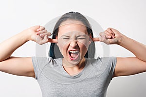 A young woman plugged her ears with her fingers