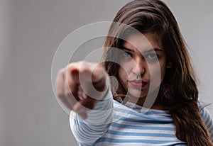 Young woman pointing an accusatory finger