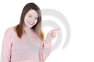 Young woman pointing side copyspace looks in camera
