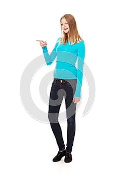 Young woman pointing to the left