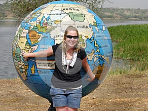 Young woman pointing to travel path on giant map