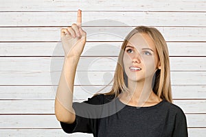 Young woman pointing up