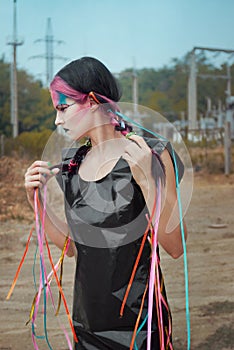 Young woman in polyethylene dress with ribbons photo