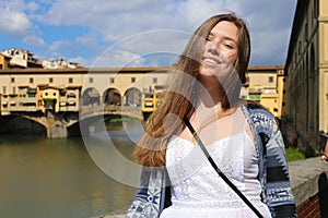 Young woman in Ponte Vecchio bridge background, florence architecture.