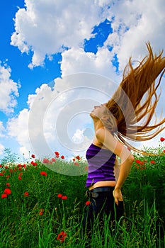 Young woman in poppy field