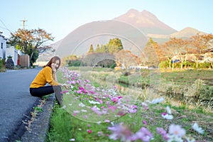 Young woman in poppy field of flowers