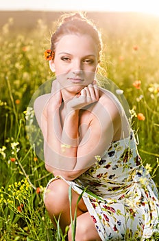 Young Woman poppy field at sunset