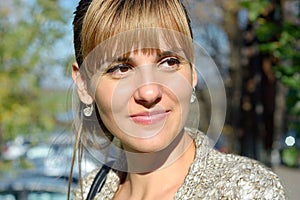 Young woman portrait with autumn leaves.