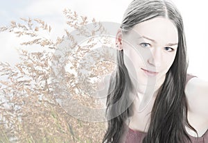 Young woman portrait on bent grass background