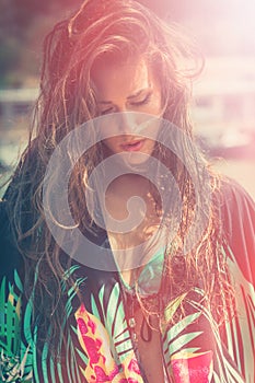 Young woman portrait in bikini and tunic hot summer day in city by the river