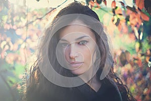 Young woman portrait in forest winter day sunset