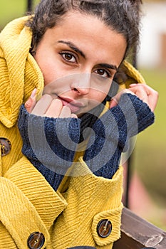 Young woman portrait in yellow coat fall