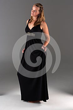 Young woman poses in evening dress