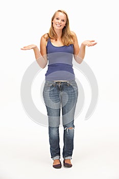 Young woman poses with shrugged shoulders