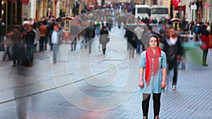 Young woman posing, busy street, people walking around, HD