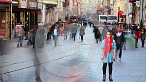 Young woman posing, busy street, people walking around, HD