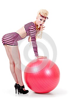 Young woman posing with exercise ball