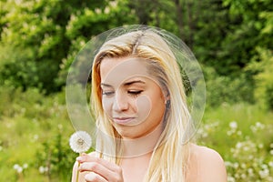 Young woman posing with flowers . Outdoor shot.