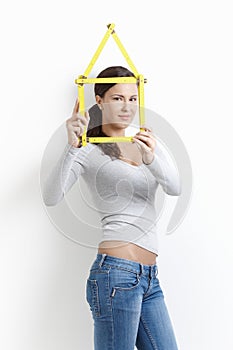 Young woman posing with folding rule smiling