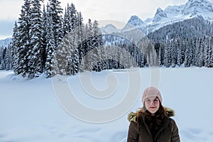 A young woman posing with the forests of Island Lake in Fernie, British Columbia, Canada behind. photo