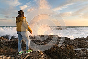 Young woman posing in front of sunset in Italy, Travel concept